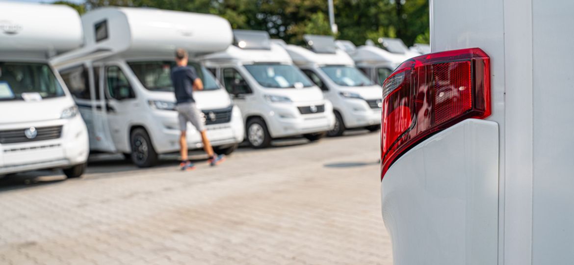 Line of Brand New Camper Vans Motorhomes Awaiting Clients on Dealership Sales Lot. Recreational Vehicles Selling. Caravanning Industry.